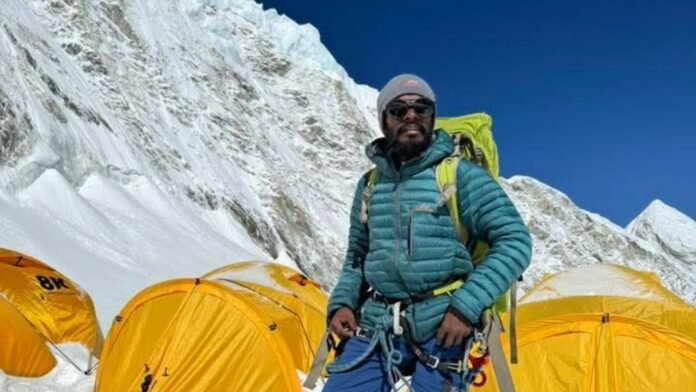 Bangladeshi adventurer Shakil on Mount Everest holding the national flag